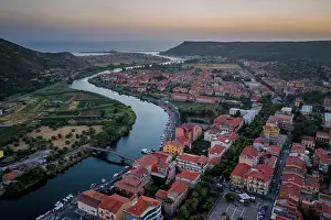 Riverbanks Prints: Bosa colorful city buildings, aerial drone view with Temo river and Mediterranean Sea at sunset