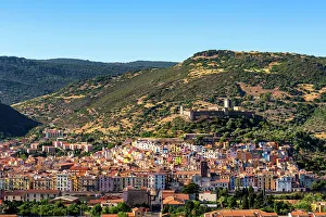 Bosa Prints: Bosa colorful city with castle on top of the hill seen from outside of the city