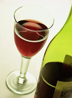 Glass Prints: A bottle and glass of red wine