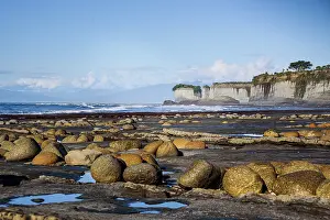 Zealand Prints: Boulders along the intertidal zone with limestone cliffs and Tasman Sea view in New Zealand's west coast