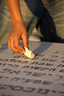 Images Dated 17th August 2007: Boy placing stone on a grave in the Mount of Olives Jewish cemetery, Jerusalem, Israel