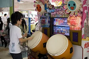 Boys Prints: Boy playing a Japanese taiko drum video game at a game center, Japan, Asia
