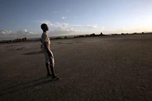 One Boy Only Prints: A boy stands in the desolate landscape of Lac Abbe, Djibouti, Africa