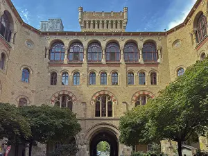 Windows Prints: Brick facade of historic building in Vienna showcasing architectural details with trees in the foreground