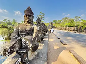 Awe Inspiring Prints: The bridge to Angkor Thom, lined on both sides with figurines ending in a corbelled arch entryway