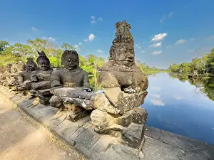 Impressive Prints: The bridge to Angkor Thom, lined on both sides with figurines ending in a corbelled arch entryway