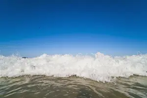 Queens Land Prints: Bright blue sky and waves breaking at Surfers Paradise Beach