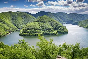 Camping Prints: Bright green landscape over Tarnita lake in summer sun with mountains and water visible from above