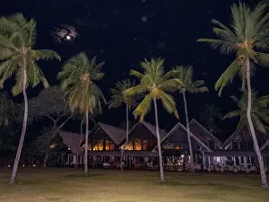 Retreat Prints: Bright full moon shines over the Anjajavay Resort by palm trees in Madagascar at night