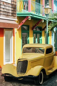 Quaint Prints: Bright streets of Philipsburg feature vintage car parked near colorful colonial houses and vibrant architecture