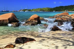 Retreat Prints: Bright sun shines on rocks and turquoise water at Anse Georgette on a sunny day in Seychelles