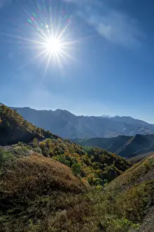 Bright Prints: Bright sun shining over remote mountain landscape in Chechnya, Caucasus region of Russia