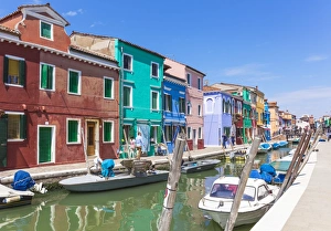 Wooden Post Gallery: Brightly coloured fishermens cottages on the island of Burano in the Venice lagoon