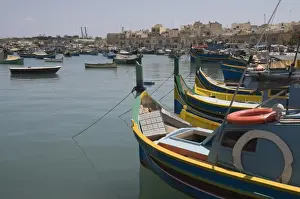 Brightly coloured fishing boats called Luzzus at the fishing village of Marsaxlokk