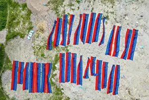 Cloth Prints: Brightly dyed cloths drying under the sun in Araihazar village during the textile dyeing process in Bangladesh