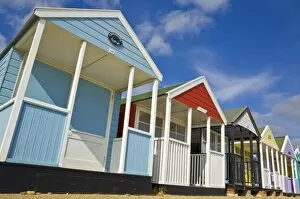 Images Dated 26th September 2009: Brightly painted beach huts in the afternoon sunshine, on the seafront promenade