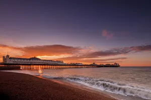 Typically English Gallery: Brighton Pier and beach at sunrise, Brighton, East Sussex, Sussex, England, United Kingdom