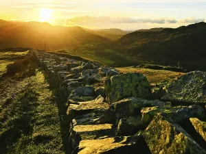 Forts Prints: British countryside mountains landscape at sunset with ruins of roman buildings site in lake district