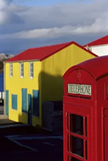 Telephone Box Prints: British red telephone box and colourful traditional house, Stanley, East Falkland