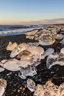 Jokulsarlon Prints: Broken ice from washed upiIcebergs on Jokulsarlon black beach at sunrise, Jokulsarlon