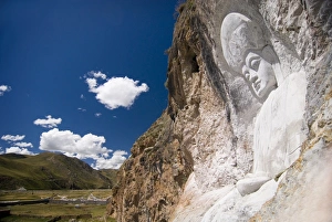 Buddha image carved into cliff side, Yushu, Qinghai, China, Asia