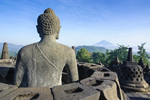 Borobodur Prints: Buddha sitting in a stupha in the temple complex of Borobodur
