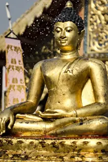 Celebrating Prints: The Buddha statue at Wat Phra Singh is blessed with water during Thai New Year celebrations