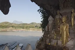 Buddhas Prints: Buddhas in Pak Ou caves, Mekong River near Luang Prabang, Laos, Indochina