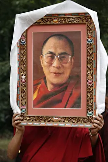 Pictures Prints: Buddhist holding a picture of the Dalai Lama, Paris, Ile de France, France, Europe