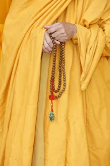 Beads Prints: Buddhist monk holding prayer beads, Thiais, Val de Marne, France, Europe