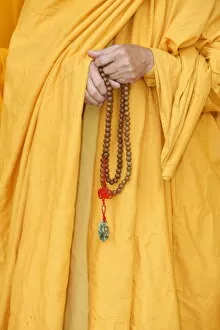 Images Dated 10th October 2009: Buddhist monk holding prayer beads, Thiais, Val de Marne, France, Europe