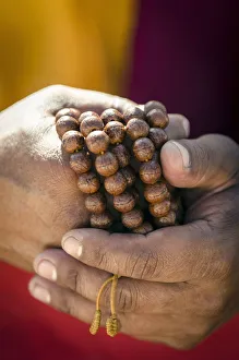 Editor's Picks: A Buddhist monk holds prayer beads (Japa Mala), Bodhnath, Nepal, Asia