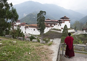 Bhutan Prints: Buddhist monk looking back at Trongsa Dzong, Bhutans largest monastery fortress