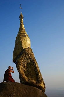 Mature Men Prints: Buddhist monk praying at the Golden Rock of Nwa La Bo