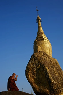 Buddhist monk praying at the Golden Rock of Nwa La Bo, Mawlamyine (Moulmein), Mon State, Myanmar (Burma), Asia