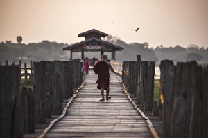 Mandalay Prints: Buddhist Monk on U Bein Teak Bridge at sunrise, Mandalay, Mandalay Region, Myanmar (Burma)