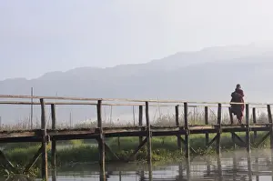 Boardwalks Prints: Buddhist monk, walking in the early morning on a wooden walkway, Inle Lake