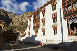 Buddhist monk walking past Hemis gompa (monastery)