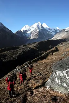Carry Prints: Three Buddhist monks carry firewood high above the mountain village of Khare