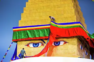 Colourful Prints: Buddhist Monks decorating the temple at Bouddha (Boudhanath), UNESCO World Heritage Site