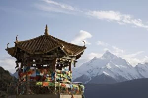 Buddhist stupa with Meili Snow Mountain peak in background, en route to the Tibetan border