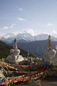 Buddhist stupas on way to Deqin, on the Tibetan Border, with the Meili Snow Mountain peak in the background, Dequin