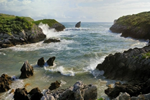 Images Dated 15th July 2009: Buelna beach and karst limestone El Picon rock pillar at high tide on a windy day, near Llanes