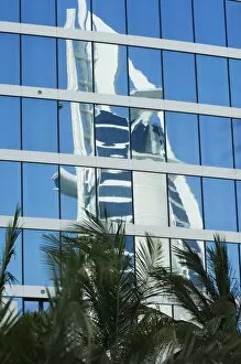 Burj Al Arab Hotel reflected in the Jumeirah Beach Hotel