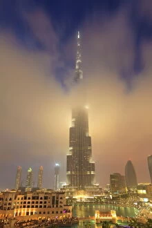 Moody Collection: Burj Khalifa illuminates the clouds and surrounding skyline at night, Downtown