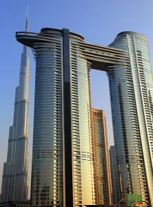 Glass Prints: Burj Khalifa towers over modern buildings in Dubai during daylight hours