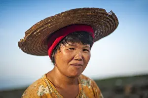 Burma Prints: A Burmese woman panning for gold in a small stream near Putao stops to have her portrait taken