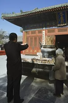 Burning incense at Taoist Donyue temple, Chaoyang district, Beijing, China, Asia