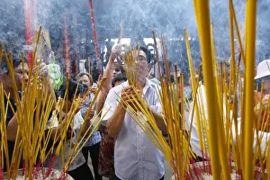 New Year Prints: Burning incense during Tet, the Vietnamese lunar New Year celebration, Thien Hau Temple
