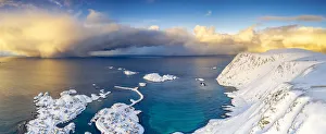Arctic Gallery: Burning sky at sunrise over the cold sea and Sorvaer village covered with snow